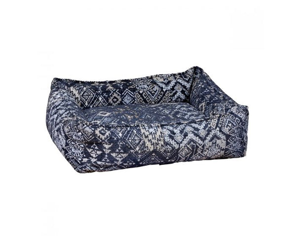 The Bowsers Mendocino B Lounge Dog Bed. It's navy blue with gray and gold design patterns
