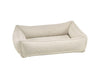 The urban lounger from bowsers Aspen bed. It is an off-white color with a raised texture in the material 