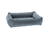 The mineral urban lounger dog bed from bowsers is light blue with a velvet looking shine. It has four sides and each with padding