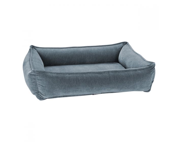 The mineral urban lounger dog bed from bowsers is light blue with a velvet looking shine. It has four sides and each with padding