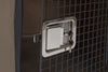A zoomed in view of the metal latch on the dakota kennel door. It has a key inserted into the key lock. The metal mesh door is open.