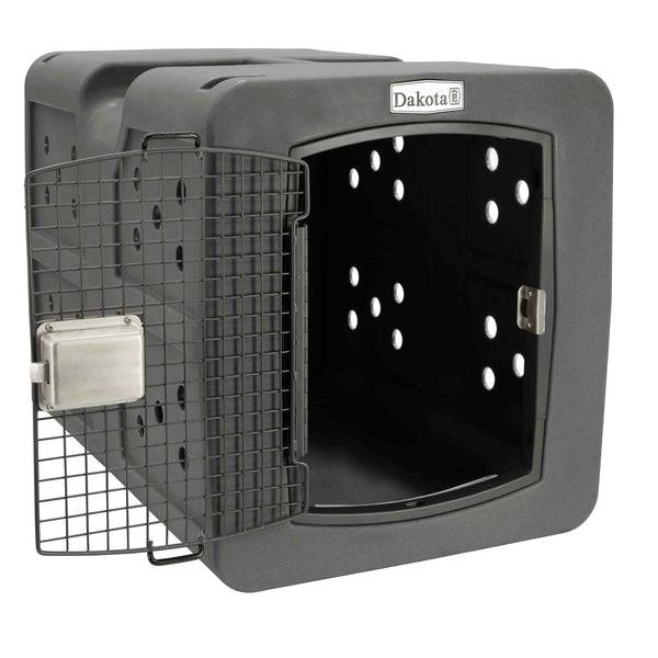 The gray dakota dog kennel. The metal door is open and inside the air rated holes are visible. Small circular holes are throughout the kennel 