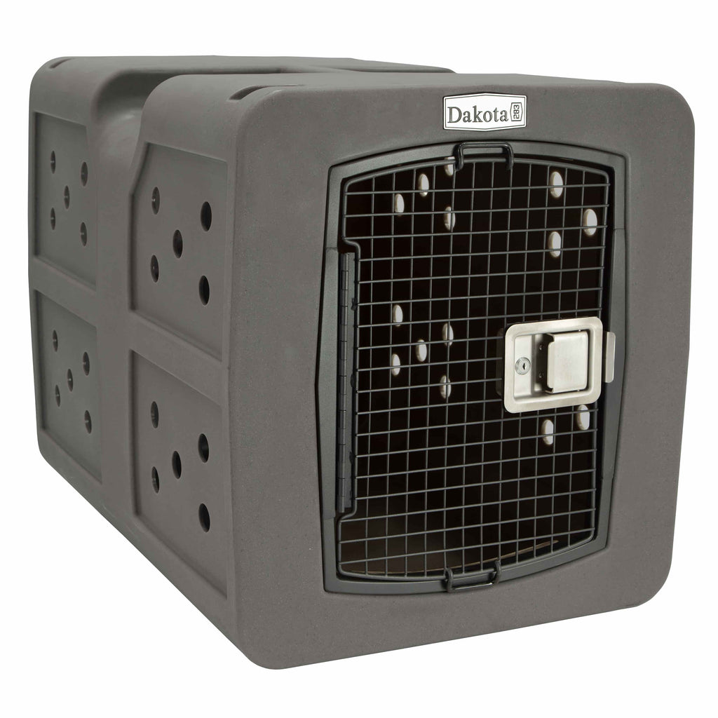 The dakota dog kennel gray colored. It is dark gray with a metal mesh front door gate. It has a silver latch and the logo is the to top center