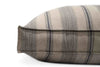 A close in view on the corner of the irish wolfhound houndry lounger dog bed. The fabric has navy stripes are muted and thin over warm gray.